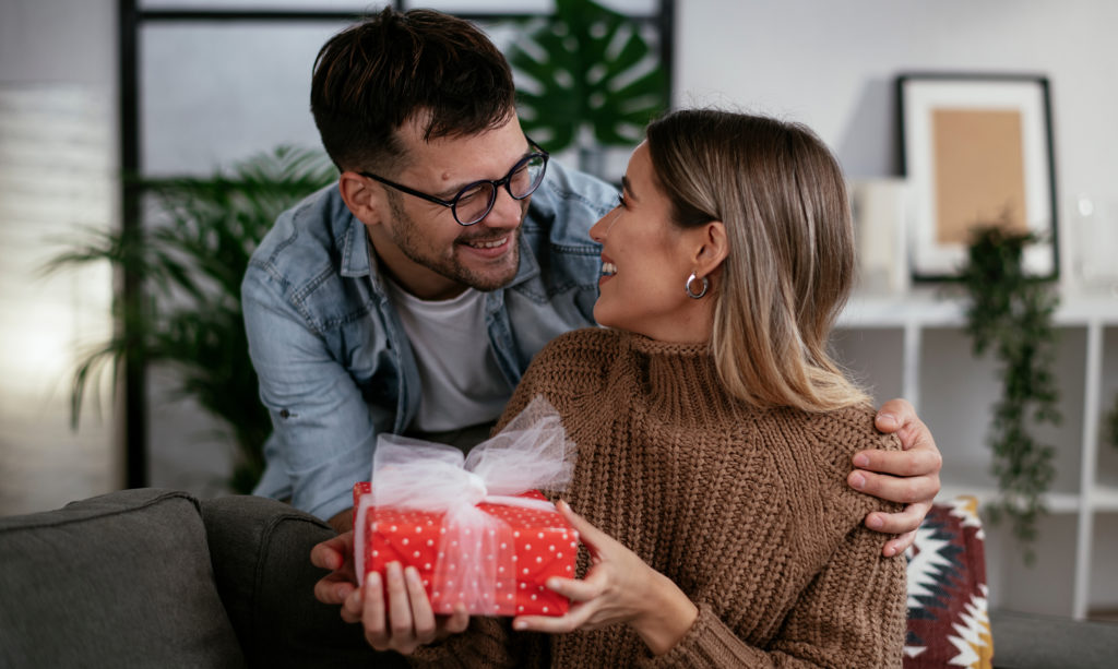 Husband surprising his wife with an anniversary gift