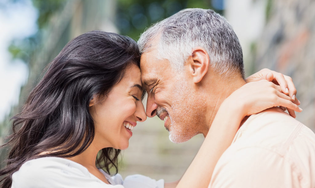 Close-up of couple embracing outdoors