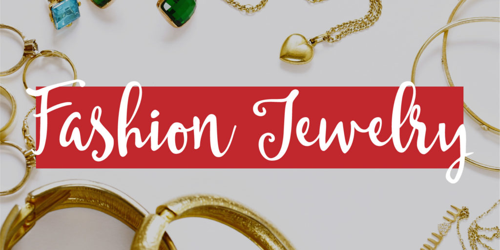 Overhead shot of jewelry on a white table with a text overlay that reads 'fashion jewelry'