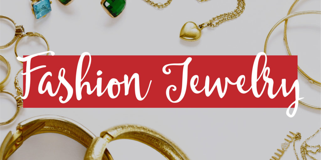 Overhead shot of jewelry on a white table with a text overlay that reads "fashion jewelry"