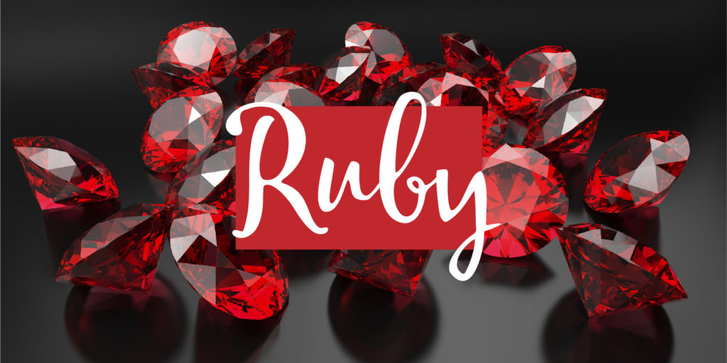 Pile of cut rubies on a dark background with a text overlay that reads 'ruby'