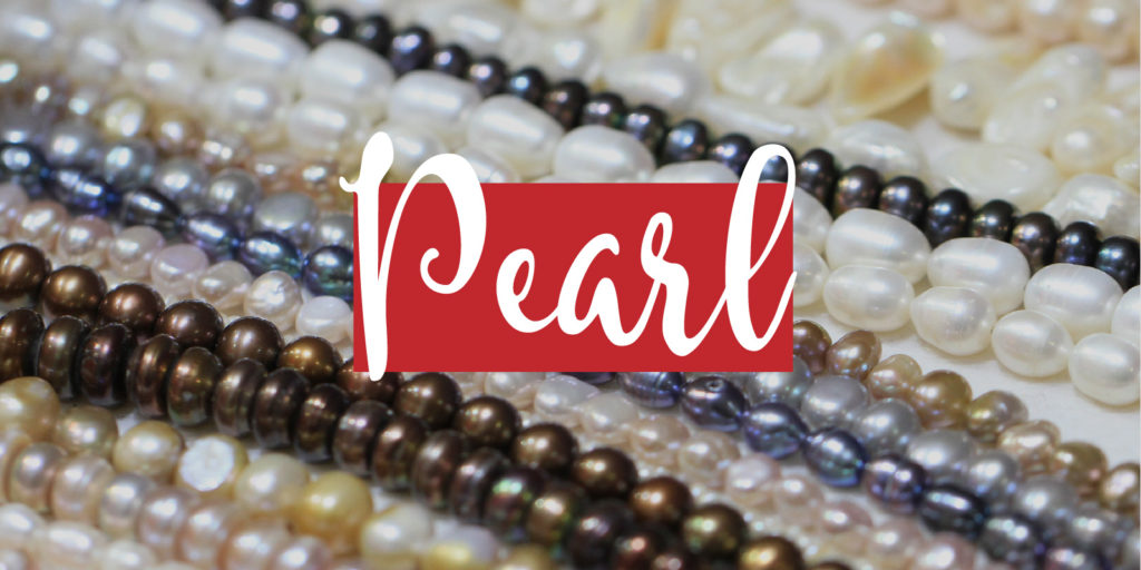 Detail image of various pearl strands with a text overlay that reads "Pearl"