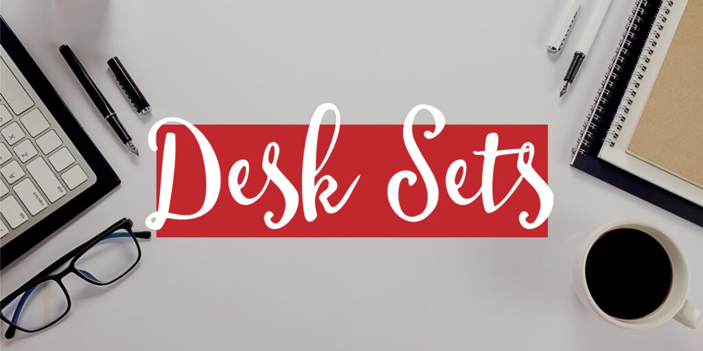 Overhead image of a desk top with a text overlay that reads "desk sets"
